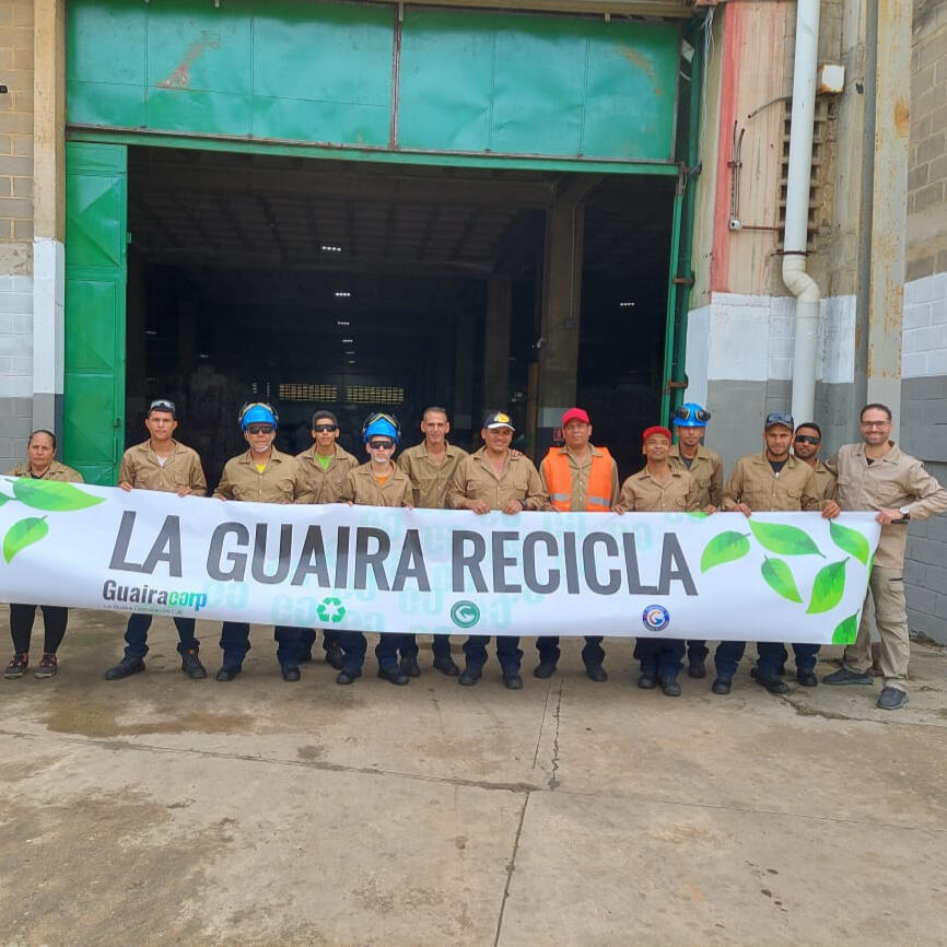 Inauguration day at L.g.c. plastic recycling Employees posing with the L.G.C. plastic recycling banner